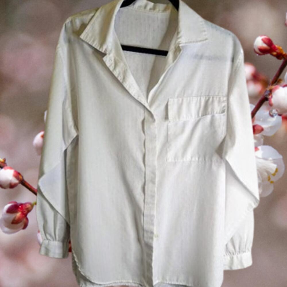 Woman's white button down front polyester front pocket blouse.